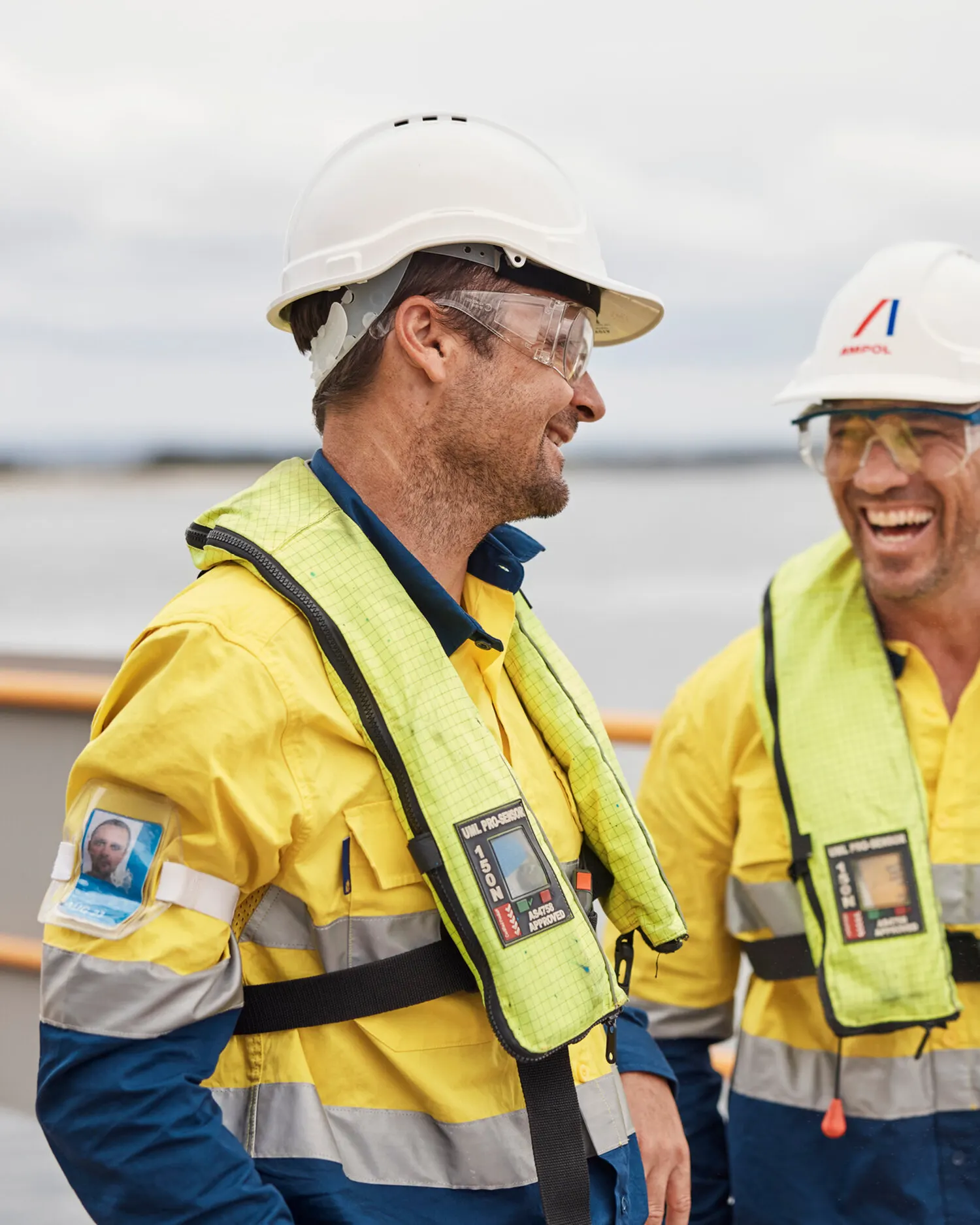 Two workers in hi-vis sharing a laugh on the job