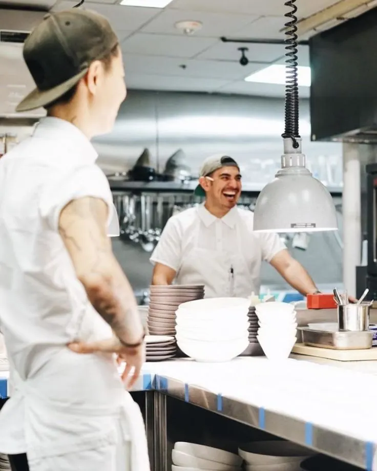 Two chefs working together in a commercial kitchen