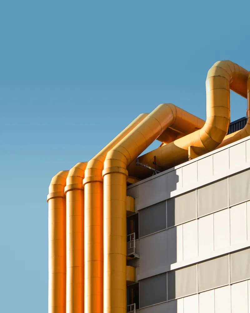 Industrial pipework against a blue sky