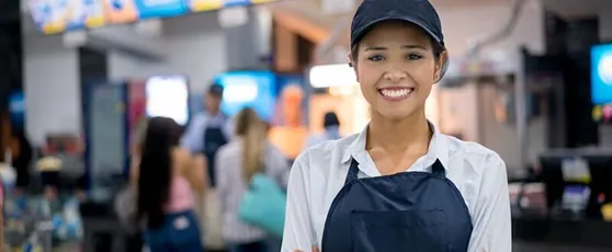 A smiling restaurant crew member
